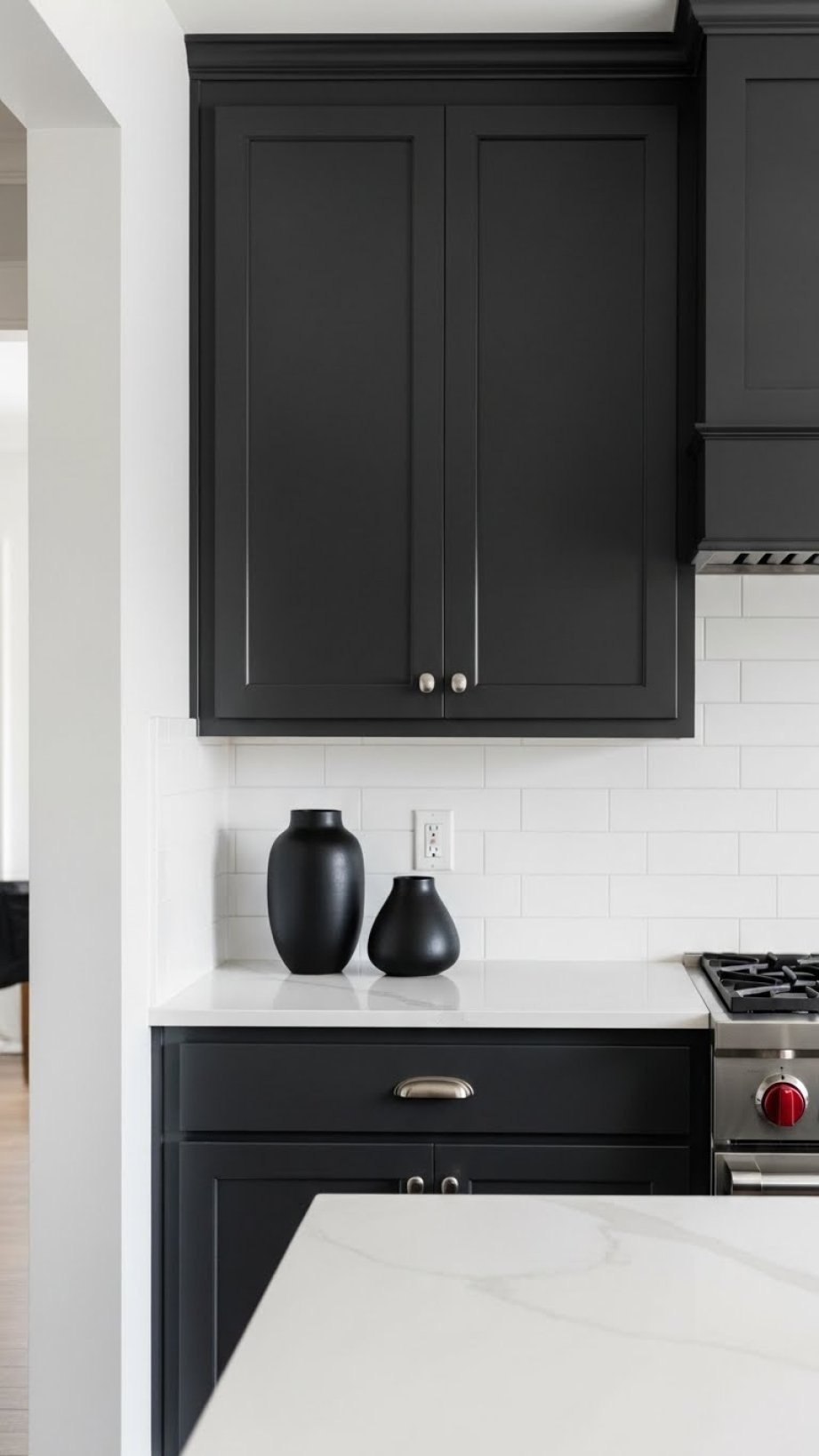 Modern charcoal gray flat-panel cabinets, white subway tile backsplash, matte black countertop. Elegant kitchen with coffee maker.